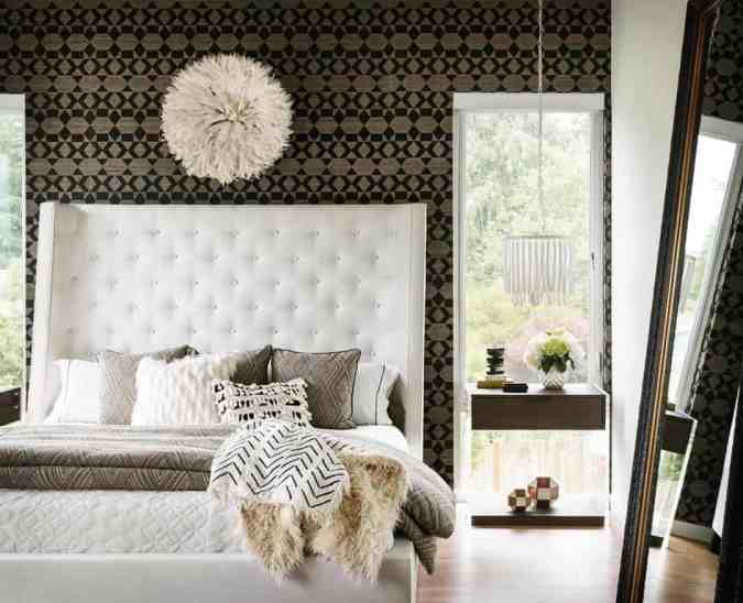 Sweet Dreams: Our 2020 Bedroom Interior Trend Predictions by Fashion Du Jour LDN. Close-up of monochrome tribal wallpaper, cream upholstered tufted bed, fur throws, black, cream, grey bedroom interior