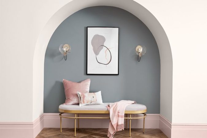 Sweet Dreams: Our 2020 Bedroom Interior Trend Predictions by Fashion Du Jour LDN. Close-up of grey and blush pink painted wall, grey and white abstract line drawing wall art,brushed chrome and glass wall light fittings, blush pink upholstered bed, teal velvet chaise lounge ottoman grey, white and blush pink bedroom interior