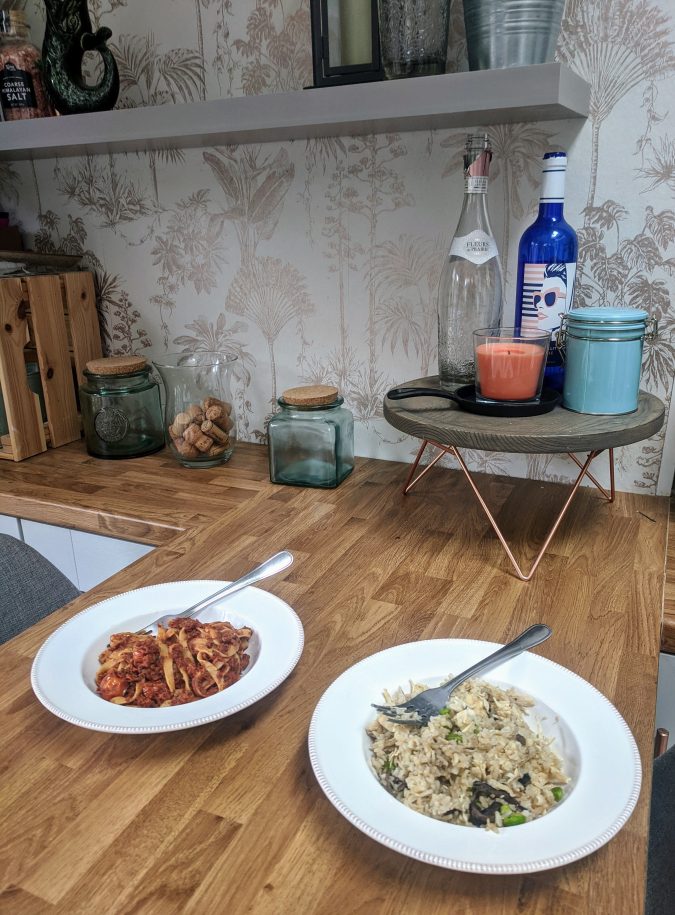 Small Prices Big Gains How Musclefood Can Transform Your Meal Time And You By Fashion Du Jour LDN. Wooden Breakfast Bar in grey kitchen. Green glass jars, copper gold accents, graham & brown copper wall paper. Two bowls of food. Musclefood Prepped Pots in Beef Ragu and Mushroom Risotto